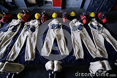 Firefighters costumes lay on the ground Editorial Stock Photo